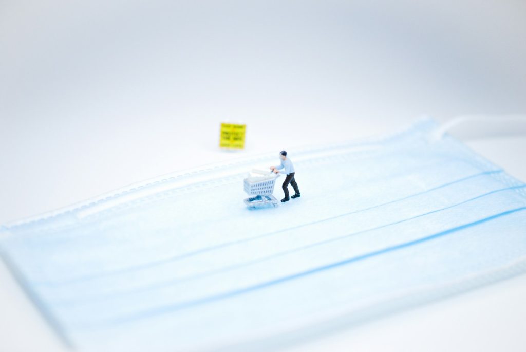 person in white jacket riding white snow sled on snow covered field during daytime